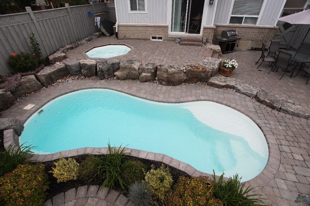 The Sundial is a classic figure-8 style swimming pool. Although it provides plenty of swim space, it's compacted into a small body of water. Holding only 6,400 gallons, the Sundial is a petite fiberglass pool shape perfect for small backyards!