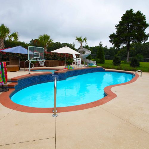 The Oasis is a free form fiberglass swimming pool designed to provide room for loads of summer fun.