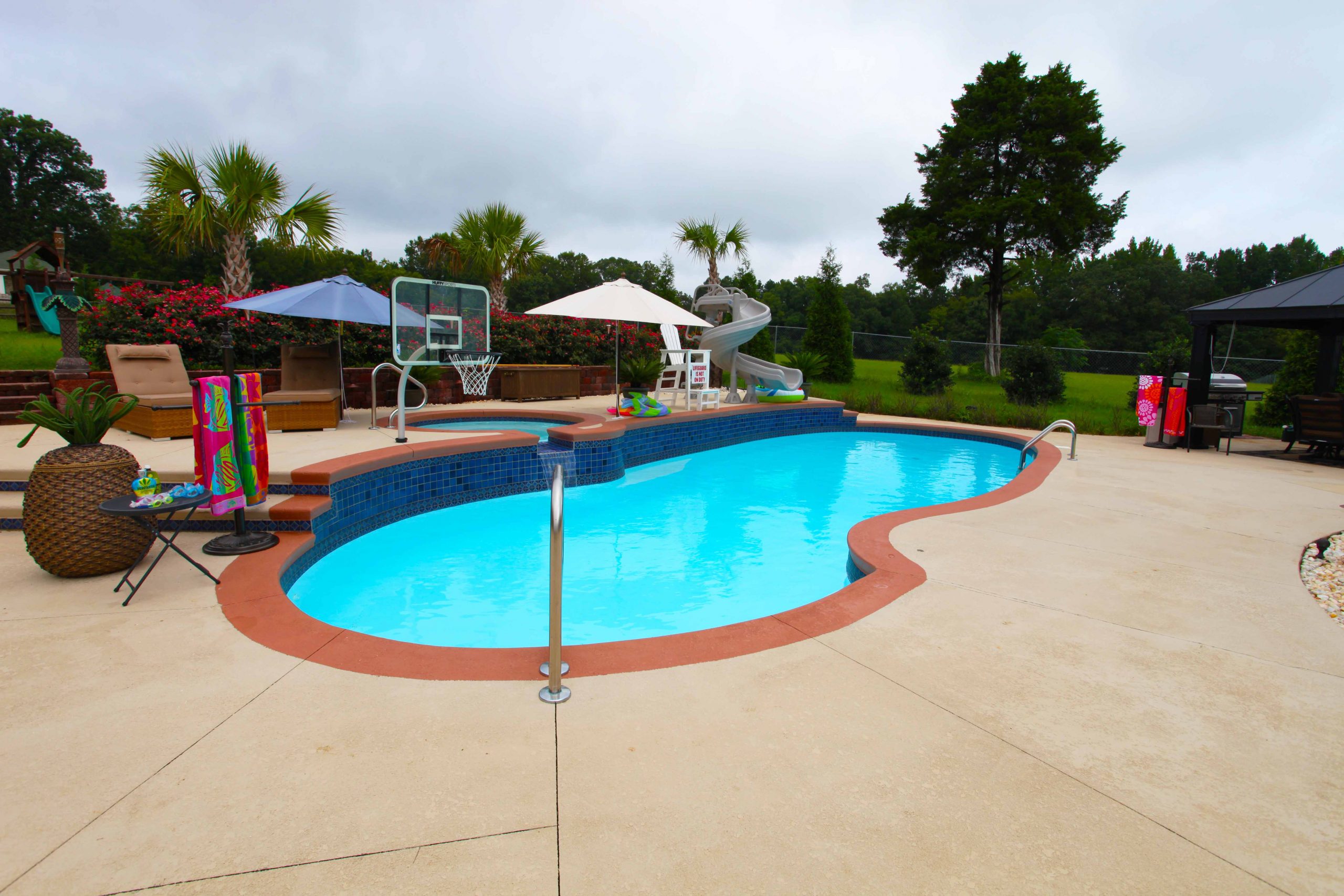 The Oasis is a free form fiberglass swimming pool designed to provide room for loads of summer fun.