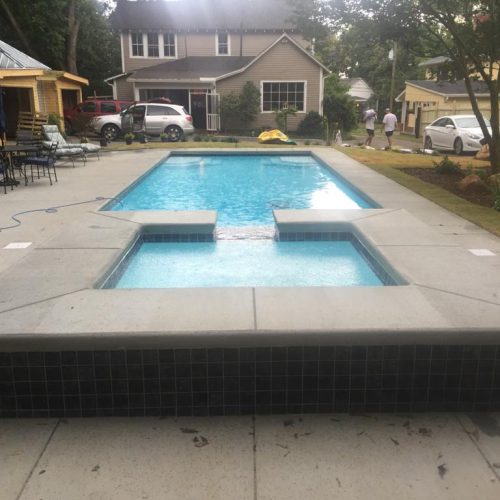 Here is another image of a Lido Spa installed with a spillover effect into the fiberglass below.