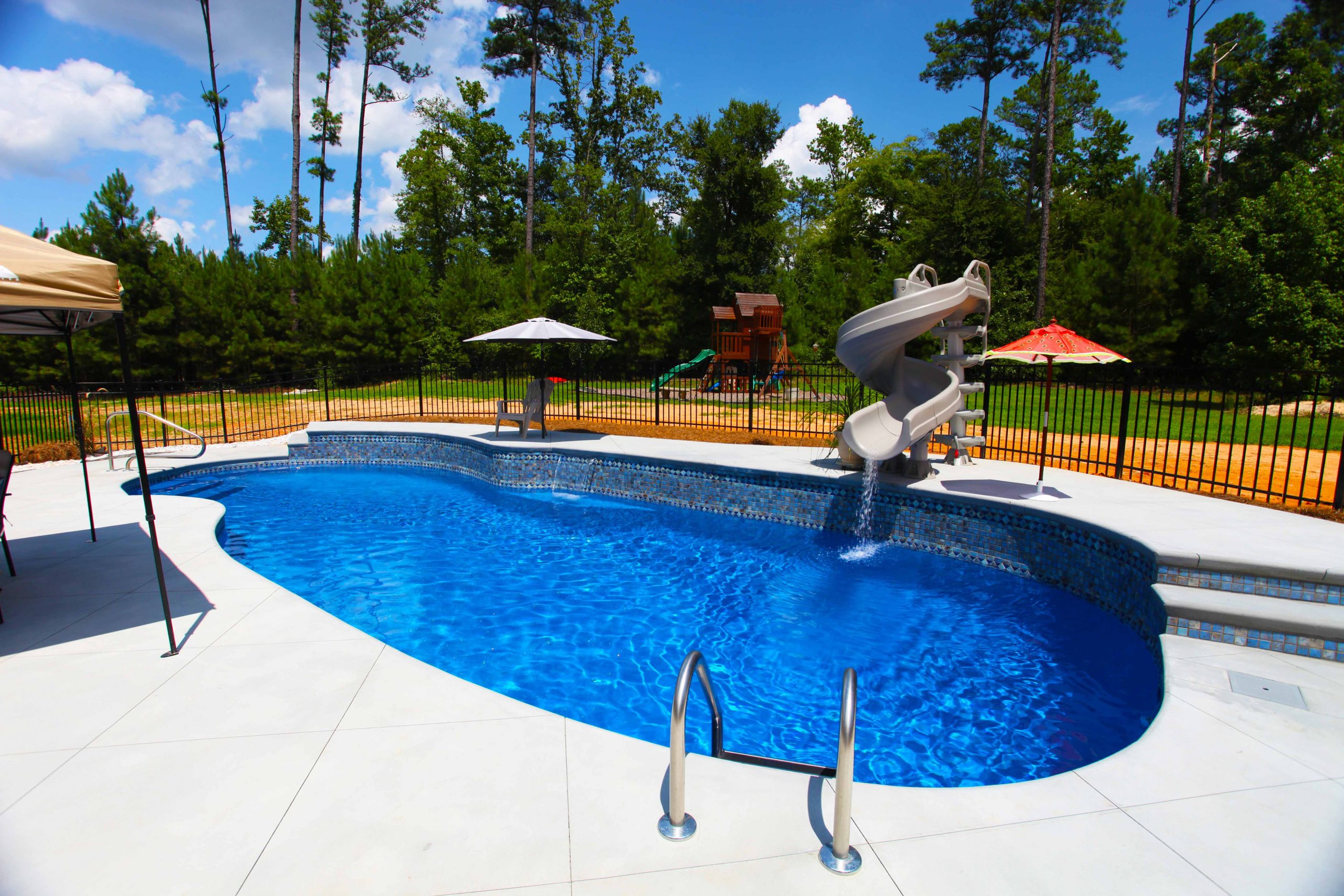 The Oasis is a free form fiberglass swimming pool designed to provide room for loads of summer fun.
