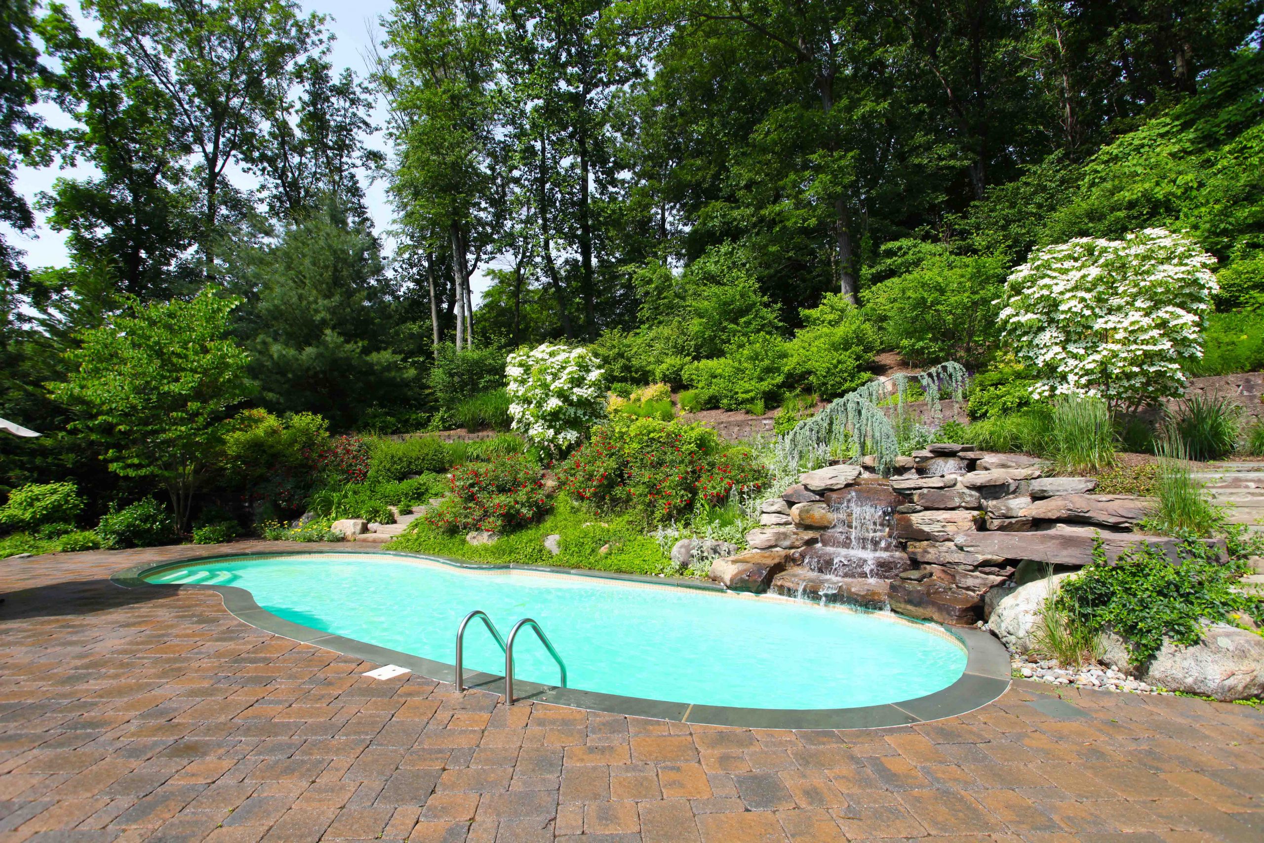 The Oasis is a free form fiberglass swimming pool designed to provide room for loads of summer fun.