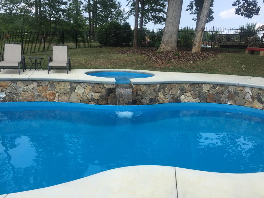 Here is another image of the Isle Spa positioned adjacent to The Cocoa Beach fiberglass pool. The Isle Spa creates a soothing accent as water gently cascades from this raised spa into the cool, crisp waters of the Cocoa Beach below. 